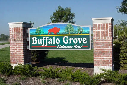 Buffalo Grove, IL welcome sign with red buffalo and green landscape on a sunny day