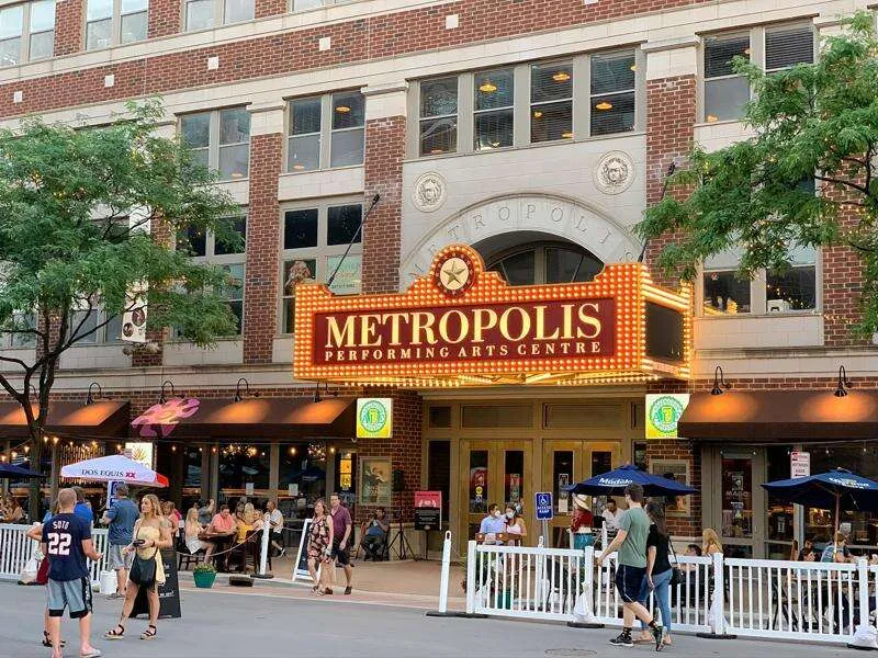 Metropolis Performing Arts Centre in downtown Arlington Heights IL with outdoor dining and pedestrian activity