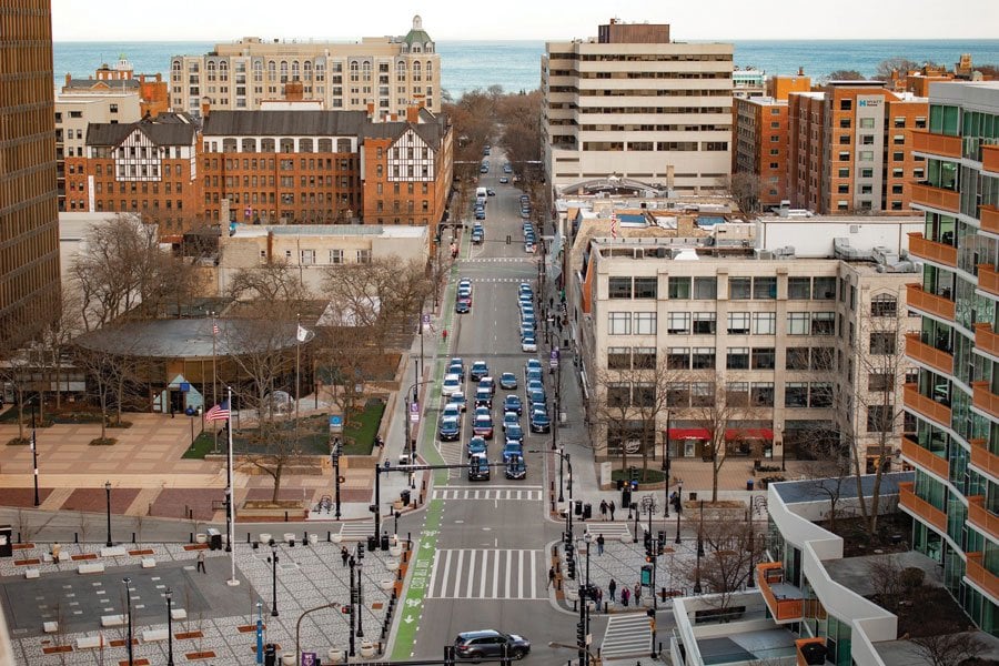 Aerial view of downtown Evanston IL showing Sherman Avenue mixed use buildings and Lake Michigan in the background
