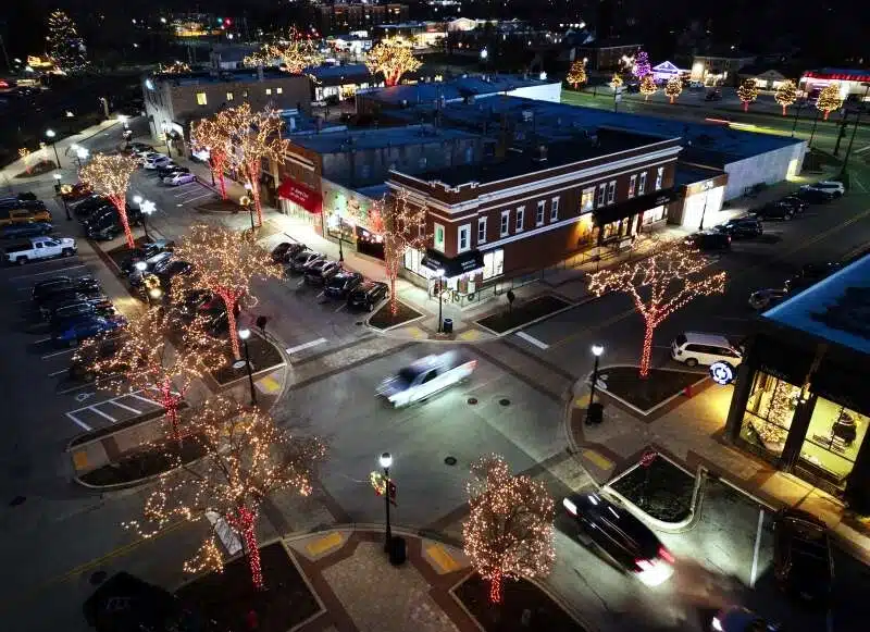 Aerial view of downtown Palatine IL at night featuring holiday lights local businesses and the vibrant town center