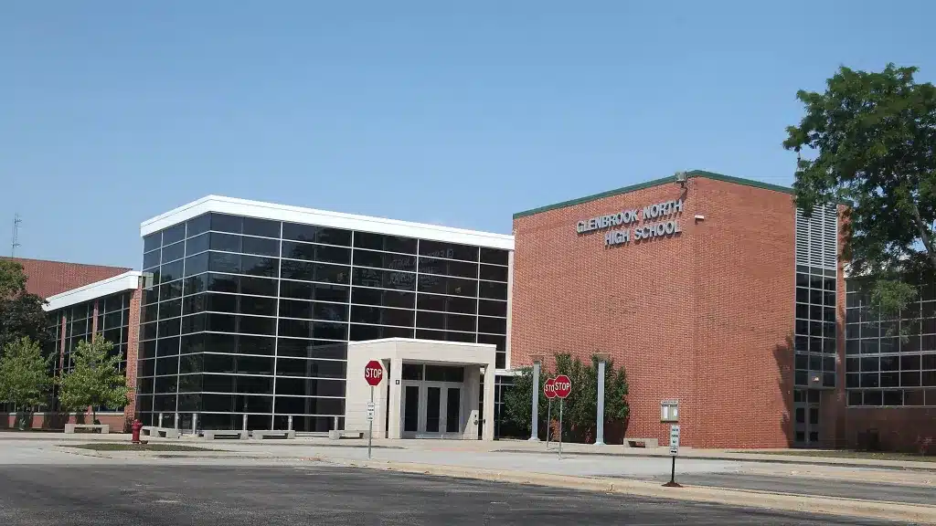 Exterior view of Glenbrook North High School campus in Northbrook IL showing the brick building and glass entrance facade