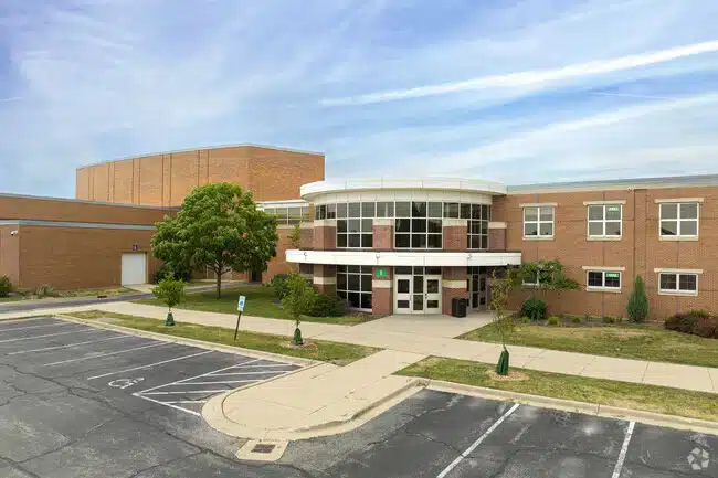 Glenbrook South High School Glenview IL | MacLagan Home Loans Wide exterior view of Glenbrook South High School campus in Glenview IL showing the full building facade and entrance area
