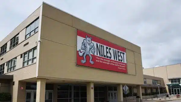 Niles West High School Niles IL District 219 | MacLagan Home Loans Exterior of Niles West High School in Niles IL showing the building facade with the Niles West Wolves school banner