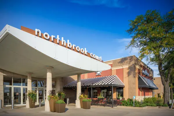 Exterior entrance of Northbrook Court shopping center in Northbrook IL with the iconic signage and outdoor seating area