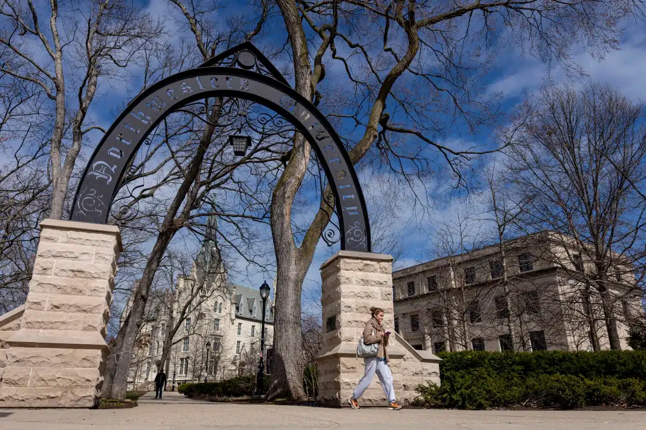 Northwestern University arch entrance on campus in Evanston IL with historic stone buildings in the background